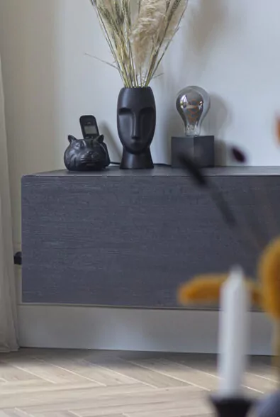 Zwevend dressoir in donker hout op een visgraatvloer in de showroom Heemskerk